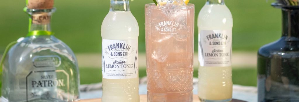 Franklin & Sons sicilian lemon tonic next to a tequila cocktail